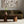Living room with a brown sofa, wooden coffee table, and abstract wall art.