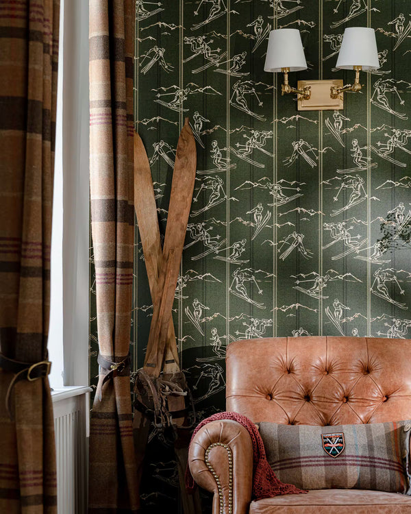 Living room with brown leather sofa, patterned wallpaper, and plaid curtains.